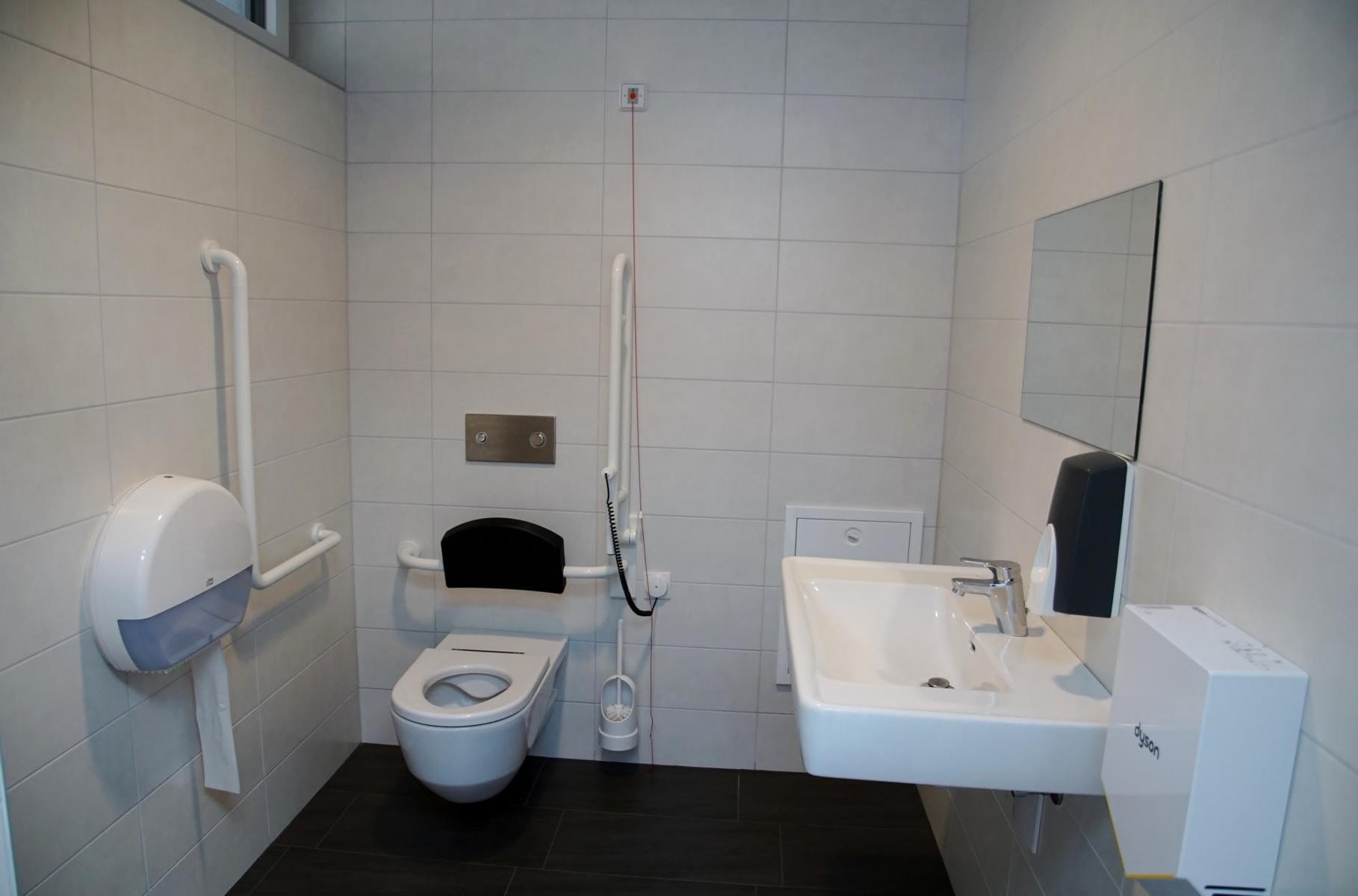 Barrierefreies WC mit Haltegriffen und unterfahrbarem Waschbecken